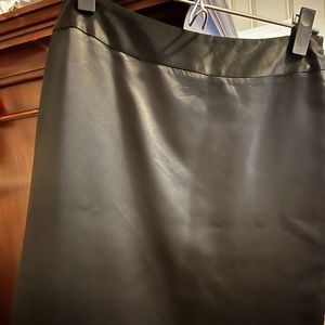 This is a beautiful black silk skirt. Must be dry cleaned. Knee length